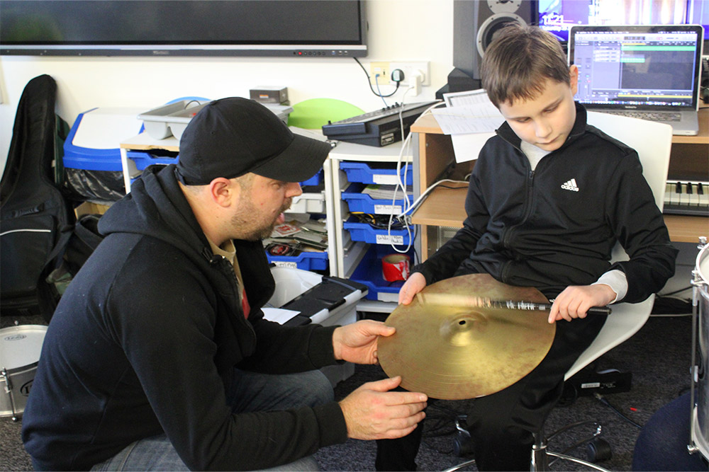 Young disabled boy learning music with Kent Music Education Charity