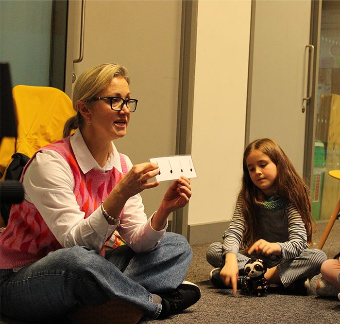 Teacher delivering music workshop with young children, singing lessons at Folkestone Music Centre, Junior Choir