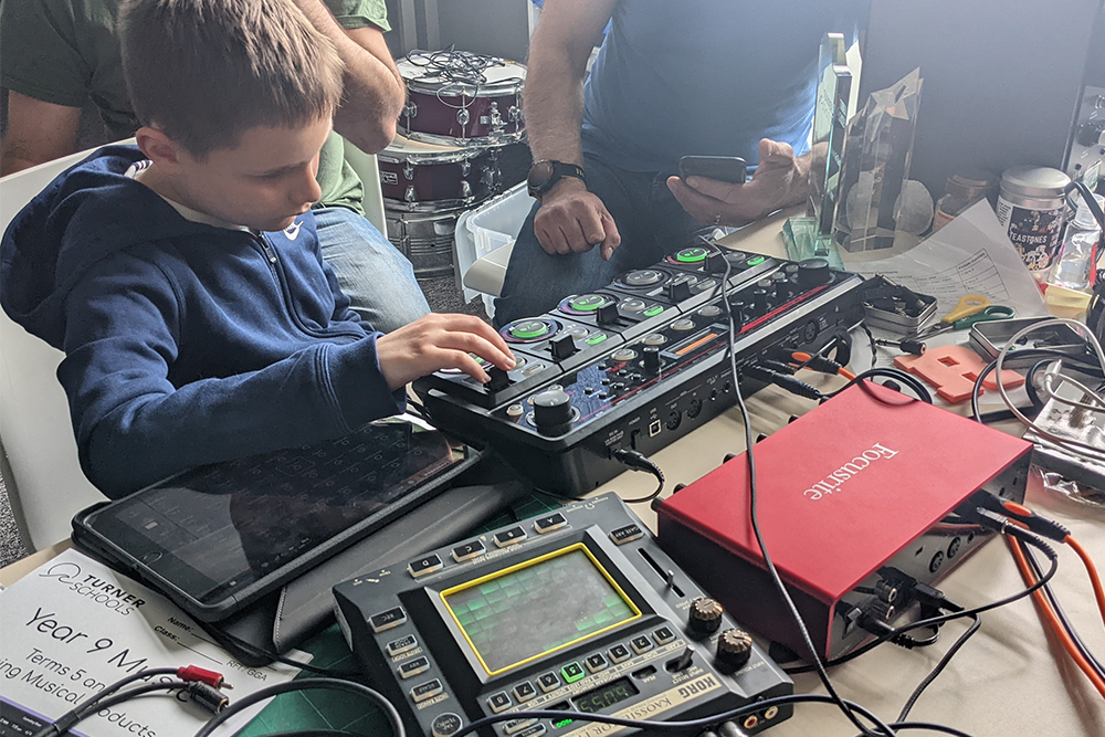 Disabled boy learning to play music at Folkestone Music Centre, Music Lab