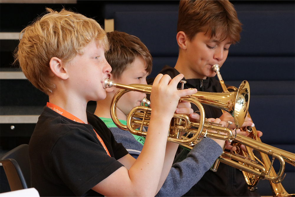 Boy playing the trumpet, brass lessons