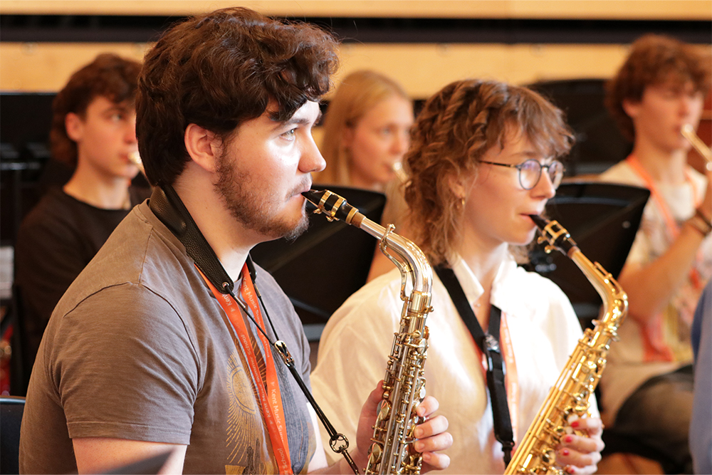 Young musicians playing the saxophone in the Kent Youth Wind Orchestra (KYWO)