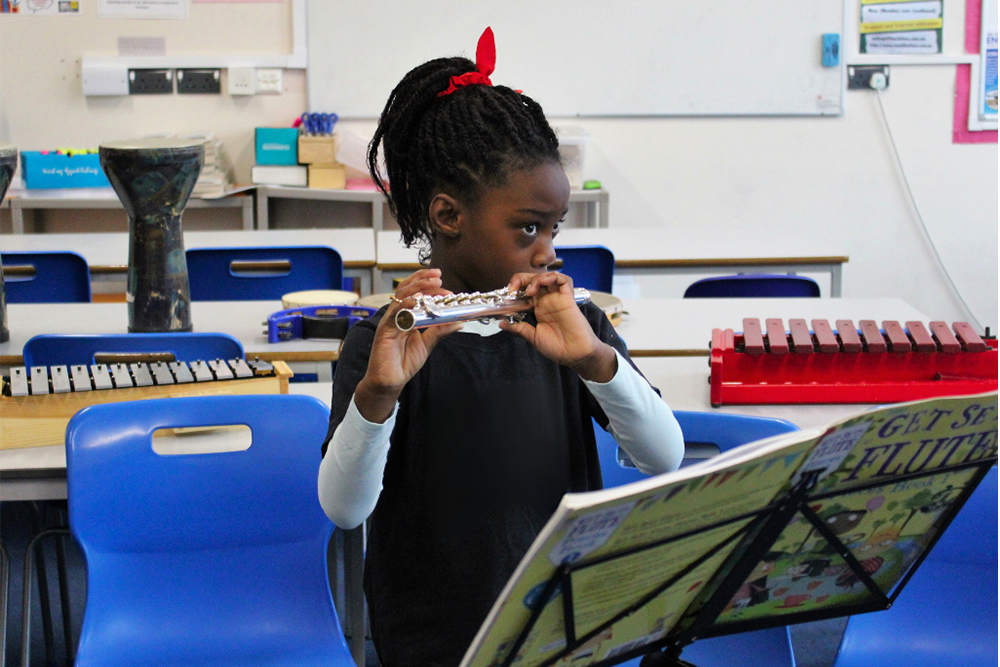 Girl playing the Flute, learning music lessons with Kent Music