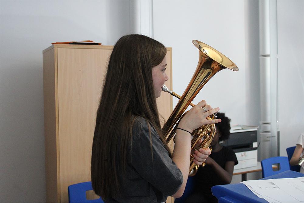 Girl learning to play the euphonium, brass instrument music lessons with Kent Music