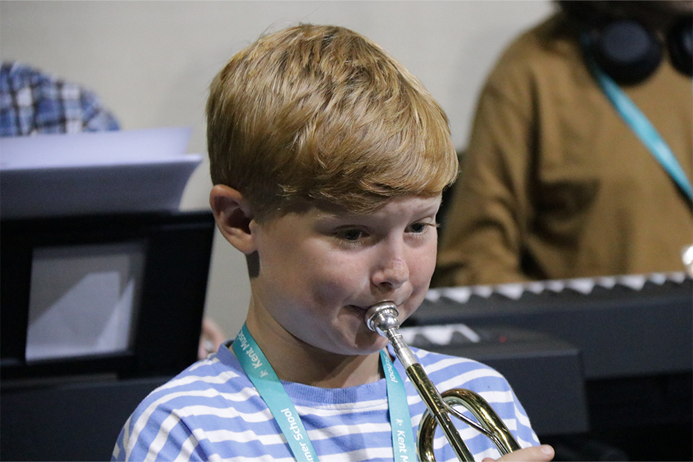 Young boy learning to play brass instrument at Maidstone Music Centre