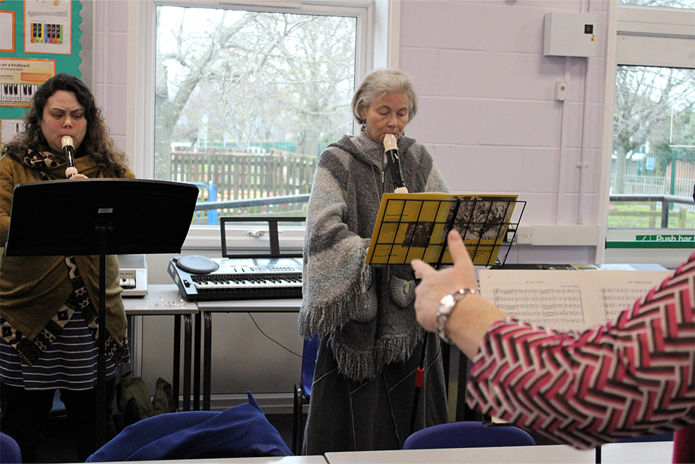 People playing early musical instruments together in the Collegium Musicum group