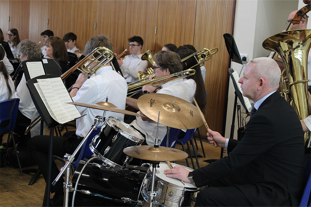Musicians performing together in the Force 10! Wind Band in Medway