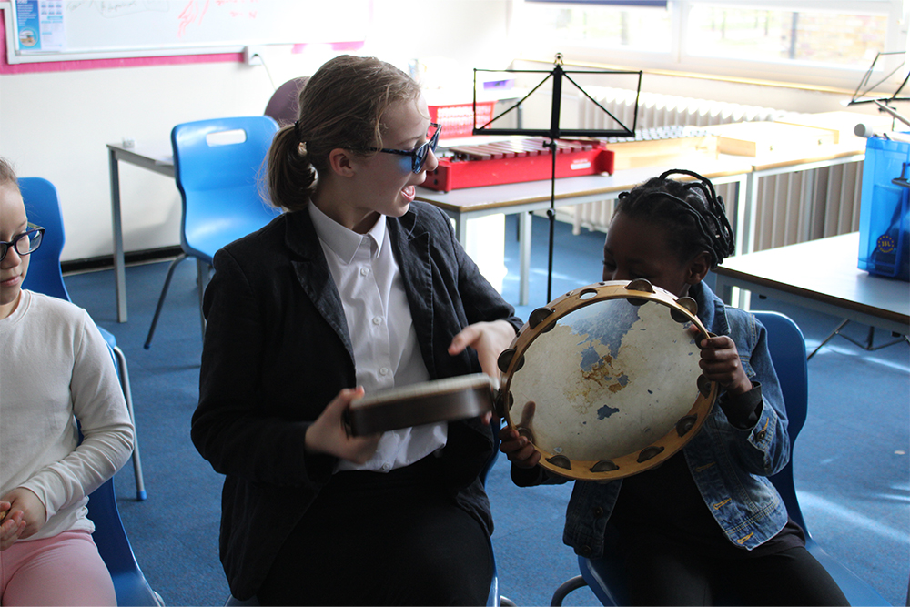 Young musicians learning about percussion instruments together