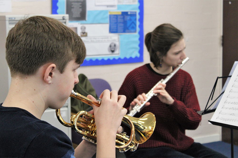 Young brass and woodwind musicians playing together in the Junior Wind Band in Medway