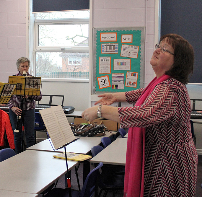 Woman conducting the Adult Recorders group