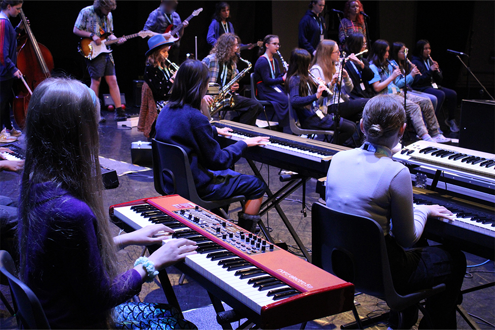 Orchestra One course students playing keyboards