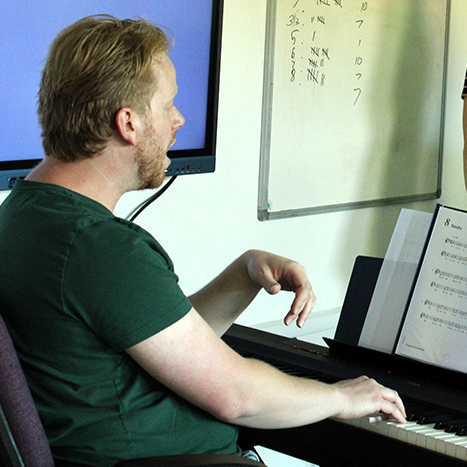 Music teacher playing the piano at Sevenoaks Music Centre