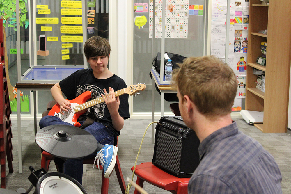 Boy learning to play the electric guitar at Thanet Music Centre, Music Lab