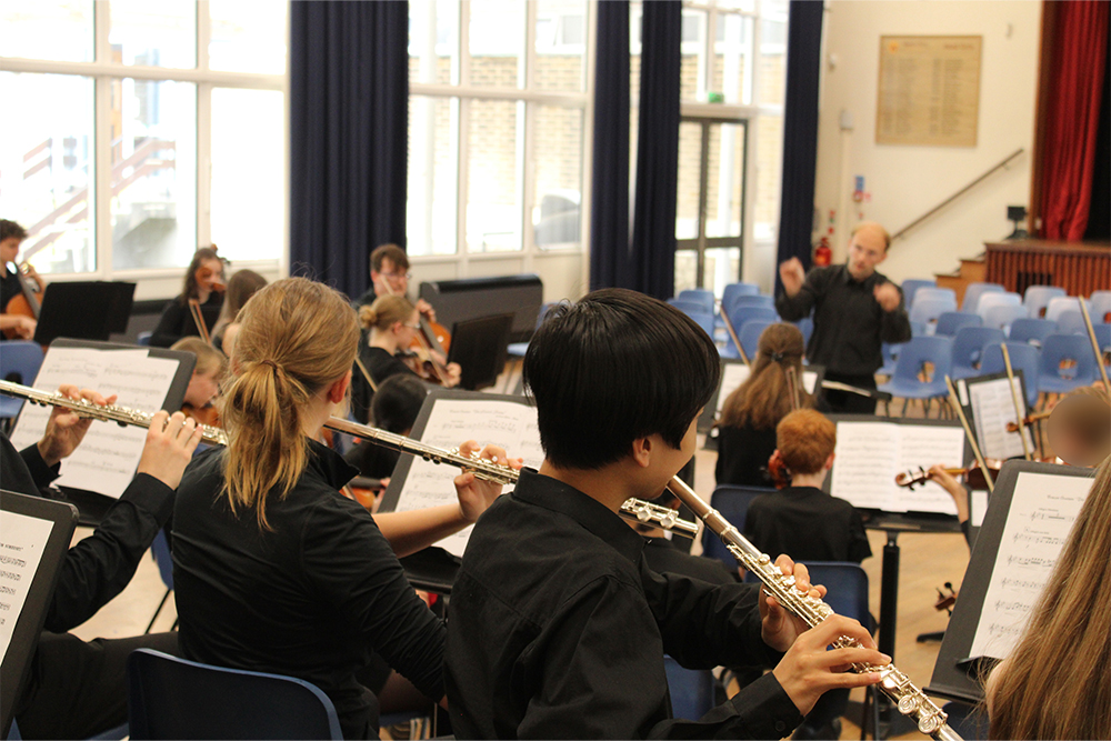 Young students performing flute together with the West Kent Youth Orchestra