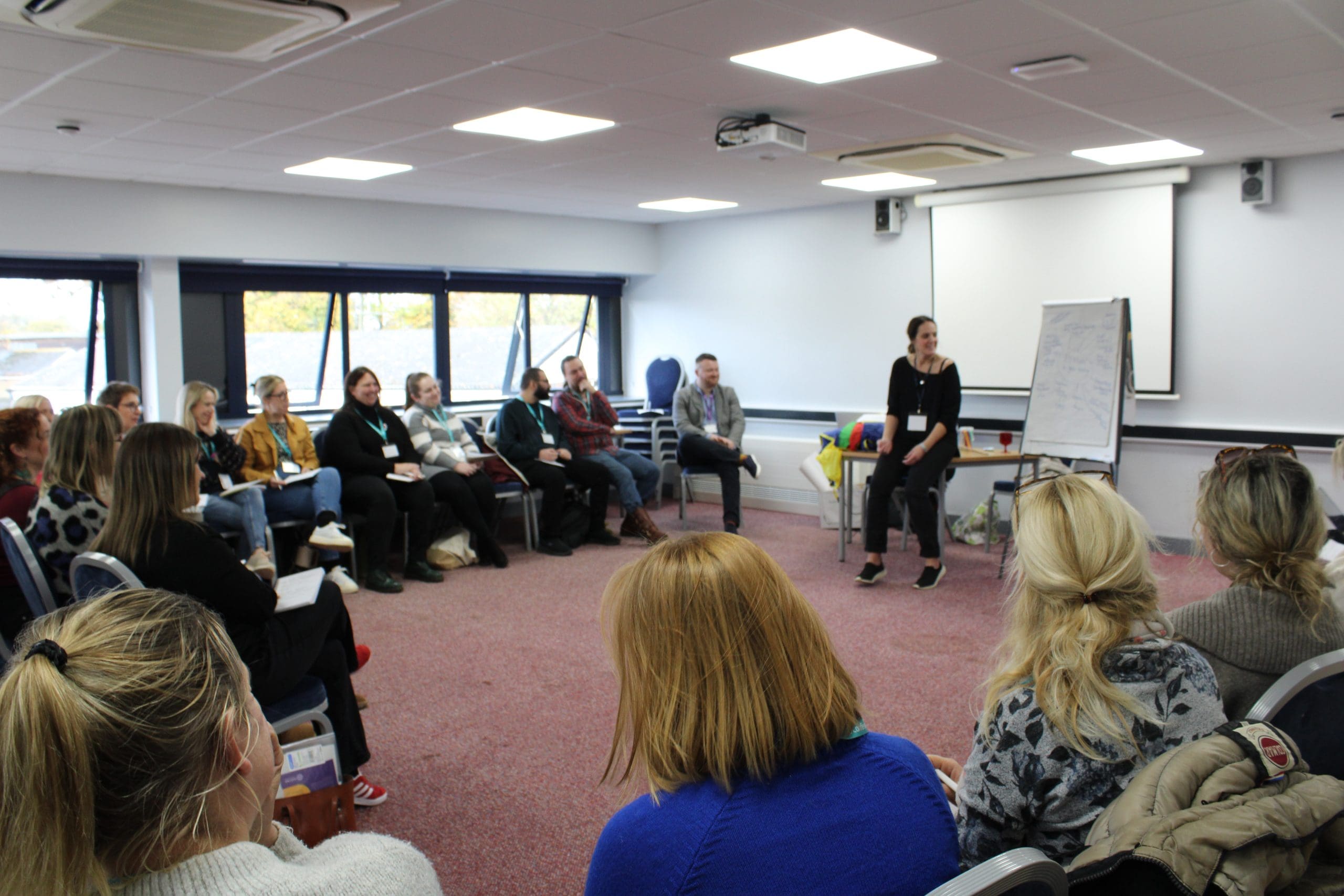 Teachers and Staff sat in a circle in a workshop for Kent Music Medway Conference